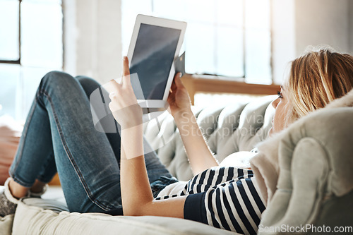 Image of Woman, tablet and credit card for ecommerce, IOT or online shopping while relaxing on living room sofa at home. Female shopper banking on touchscreen with bank card for purchase, app or sale on couch