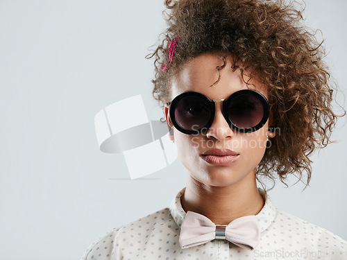 Image of Black woman, fashion and sunglasses portrait in studio for funky, quirky and trendy people style. Assertive face of fashionista person in isolated gray background for marketing mockup.