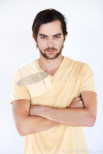 Image of Man, arms crossed and serious fashion portrait isolated on a white background with mockup space. Face of male Europe model with a beard posing for magazine cover, advertising or marketing in studio