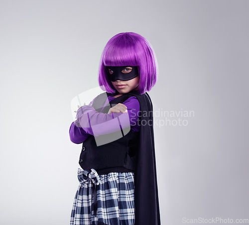 Image of Portrait, girl and mask for costume, hero and confident kid isolated on grey studio background. Face cover, female child and superhero with confidence, dress up and fantasy for cosplay and creative