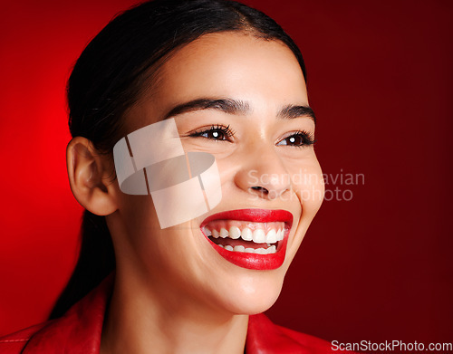 Image of Woman, makeup and smile with lipstick in studio for beauty, cosmetics or self love with glow face. Model, natural cosmetic shine or skin wellness for self care, health and aesthetic by red background