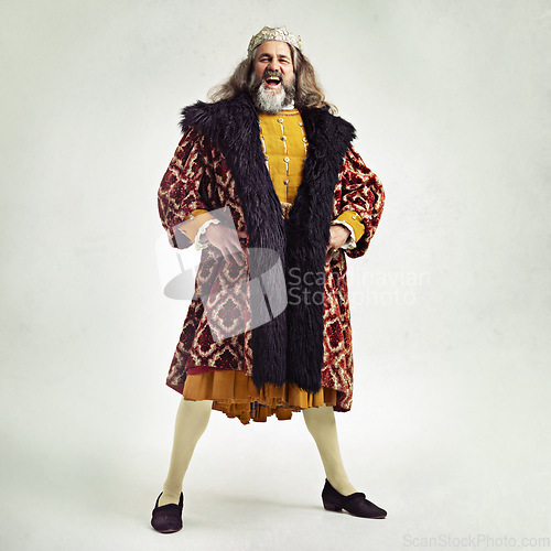 Image of King, crown and portrait with a royal man in studio on a gray background during the renaissance period of history. Medieval, victorian and royalty with a male ruler posing as leader of his kingdom