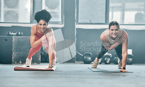 Image of Woman, fitness and friends in class on mat for workout, exercise or training at the gym. Portrait of happy women with smile for healthy exercising balancing on arm for plank or cardio at gymnasium