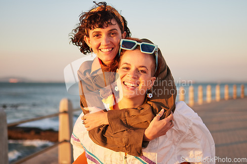 Image of Lesbian, portrait and couple of friends at the beach in piggyback, support and happy for lgbtq love. Sunset, sea and smile of women or gay people on summer date with pride, freedom and gen z holiday