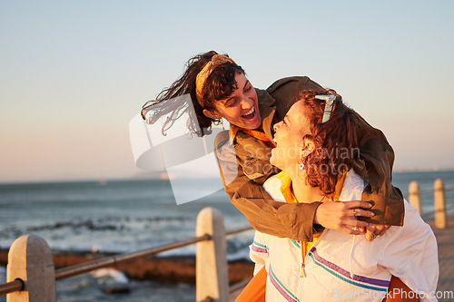 Image of Women, gay couple and piggyback by the ocean coast with smile for happy relationship and fun pride in the outdoors. Lesbian woman on back ride with partner laughing in joy and happiness by the beach