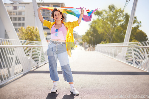 Image of Rainbow, flag and lgbt woman portrait of a person with human rights, sexuality and equality support. Freedom, smile and gen z female on a urban city bridge with celebration of lgbtq with happiness