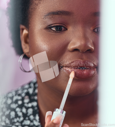 Image of Black woman, makeup and lipstick for beauty, cosmetics or glow and gloss for facial treatment in the bathroom. African American female applying cosmetic product to lips or mouth with stick brush