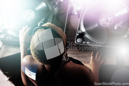 Image of Black woman, DJ and music for party, club or event in celebration, sound or energy with technology. African American female musician with turntable for disco, concert or audio track at nightclub