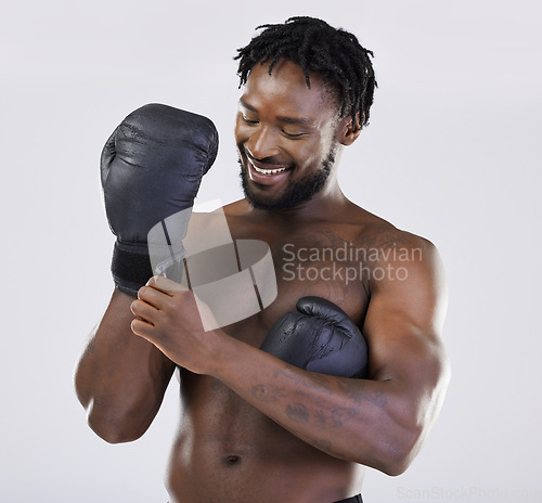 Image of Boxing, fitness and black man happy about fight for sport training and workout in studio. Athlete boxer gloves for exercise, performance and mma competition with power and energy for motivation