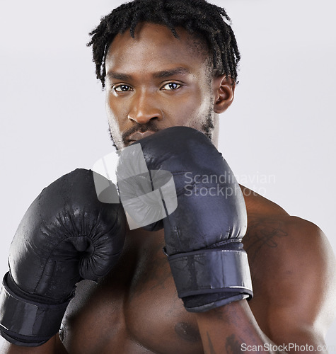 Image of Boxing gloves, strong man and fitness portrait to fight for sports training and workout in studio. Athlete boxer person ready for exercise, performance and mma competition with power and energy