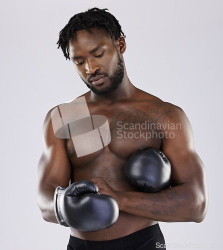 Image of Fitness, boxing gloves and black man fight for sports training and workout in studio with strong muscle. Athlete boxer person ready for exercise, performance and mma competition with power and energy