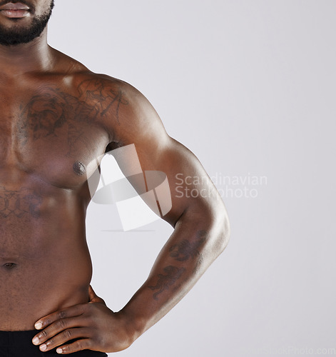 Image of Closeup, black man and fitness for with health, muscular or wellness with guy on grey studio background. African American male, athlete or bodybuilder bare, chest or pecs with motivation for exercise