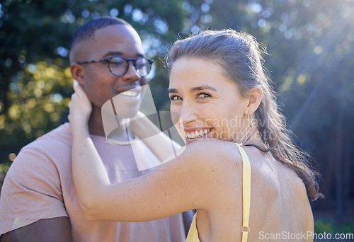 Image of Happy woman, smile and interracial couple for hug, love or care for summer holiday, relationship or bonding in the park. Female holding man smiling in happiness for quality time, romance or embrace