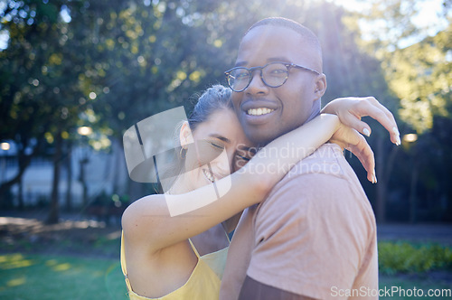 Image of Summer, love and interracial with a couple bonding outdoor together in a park or natural garden. Nature, diversity and romance with a man and woman hugging while on a date outside in the countryside