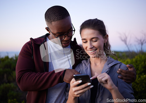 Image of Hiking, travel and couple with phone on mountain for location, gps mobile app and health tracking. Fitness, dating and interracial man and woman with smartphone for adventure, freedom and nature hike