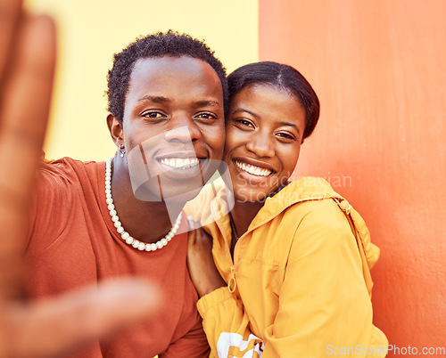 Image of Selfie, love and memories with a black couple posing for a photograph together on a color wall background. Portrait, happy and smile with a man and woman taking a picture while bonding outside