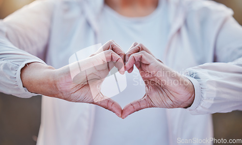 Image of Heart, fitness and senior hands with health in cardio, sports or training with wellness love, hope and health background. Support, healthcare and retirement love sign of woman in exercise or workout