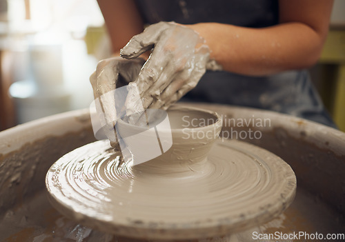 Image of Hands, clay and pottery with a woman designer working in a studio or workshop for art, design and ceramics. Creative, sculpture and wheel with a female artist at work as a potter or ceramic artisan