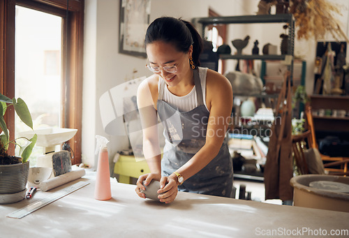 Image of Small business, art and pottery girl entrepreneur in workshop with clay for creativity and inspiration. Creative asian woman working at artistic workspace with happy smile in Tokyo, Japan