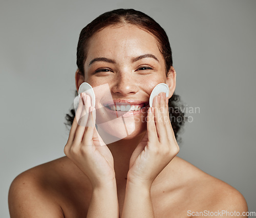 Image of Skincare, beauty and portrait of a woman with cotton for face acne, cosmetic cleaning and dermatology glow on a studio background. Cosmetics, happy and model with clean pads for facial wellness