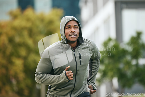 Image of Fitness, runner or black man running in city for body training, exercise or workout with focus in Miami, Florida. Freedom, mindset or healthy sports athlete with wellness goals, motivation or mission