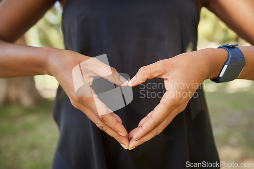 Image of Hands, heart sign and fitness with a yoga black woman outdoor for meditation, mental health or wellness. Nature, peace and park with a female athlete meditating outside for loving peace or balance