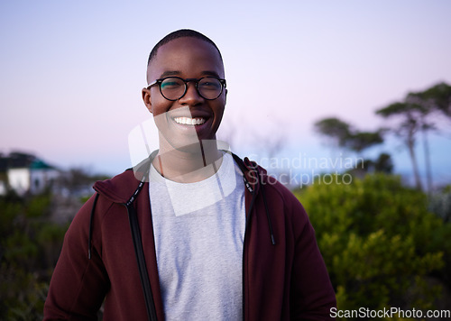 Image of Happy, smiling and portrait of a black man in nature for fun, relaxation and walking in Turkey. Smile, peace and calm African person in a park for an environment walk, adventure and zen during sunset