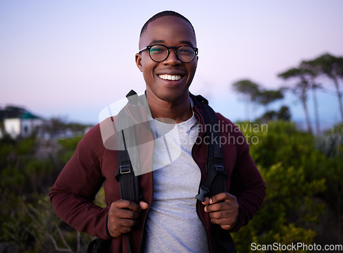 Image of Portrait, hiking and nature with a black man outdoor for health, freedom or adventure in the evening. Hike, hobby and recreation with a handsome young male hiker carrying a backpack alone outside