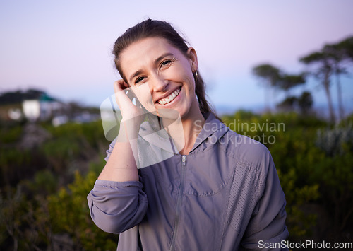 Image of Happy, beautiful and portrait of a woman in nature during sunset for peace, calm and zen. Adventure, hike and smile of a girl on a walk for fitness, cardio and relaxing during dawn in a park