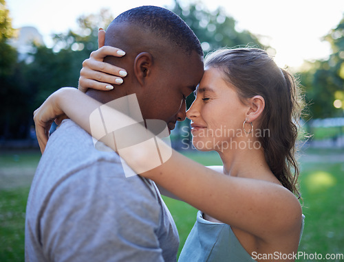 Image of Love, forehead and interracial couple, outdoor and quality time for bonding, romantic and loving together. Romance, black man and woman hug, embrace and relationship with intimate and facial contact