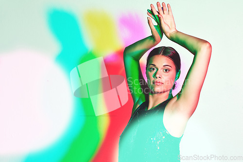 Image of Portrait, dance or kaleidoscope and a ballet woman in studio on a white background with a colorful backdrop. Art, music and performance with a female dancer or ballerina on a multicolor wall