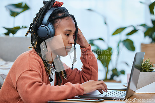 Image of Thinking, black woman and laptop for remote work from home, concentration and typing with connection. Jamaican female, lady and freelancer with audio to text, focus and online research for project