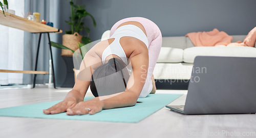 Image of Stretching, yoga or woman in online class for fitness exercise or live streaming a workout at home. Extended dog pose, laptop or healthy person with a flexible spine training body in zen meditation