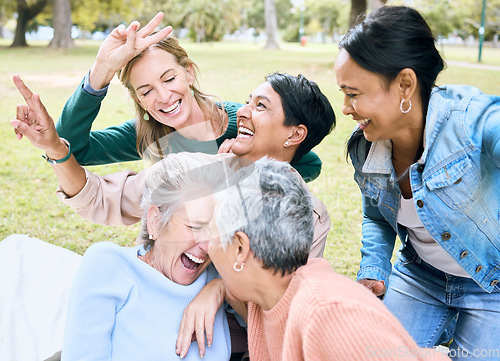 Image of Retirement, women and laughing in funny games, comic bonding and silly global activity with peace sign hands. Smile, happy and elderly senior friends in nature park, grass garden or community support