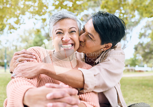 Image of Couple of friends, portrait or cheek kiss in nature park, grass garden or relax environment in support, love or retirement. Smile, happy or senior women in elderly bonding, fun embrace or trust hug