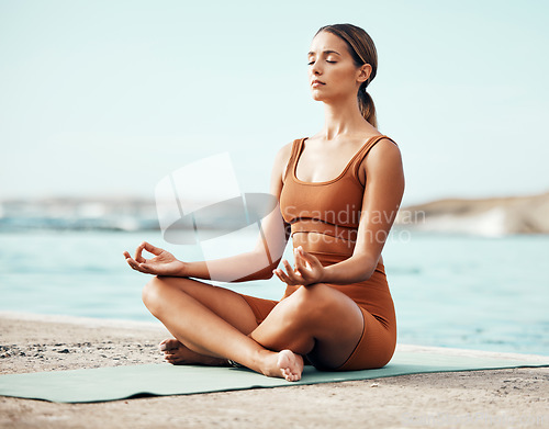 Image of Beach meditation yoga, peace and woman meditate for chakra energy healing of soul, aura or spiritual balance. Zen freedom, pilates and girl relax for mental health, mindset wellness or mindfulness