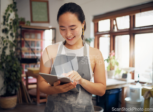 Image of Business owner, Asian woman and tablet for connection, digital marketing or artist in studio. Female creative, lady or entrepreneur with online planning, ceramic store or smile for project or startup