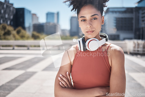 Image of Fitness, headphones and black woman in portrait for workout, exercise or training motivation, mental health and wellness in city. Face of a sports athlete with music audio subscription or technology