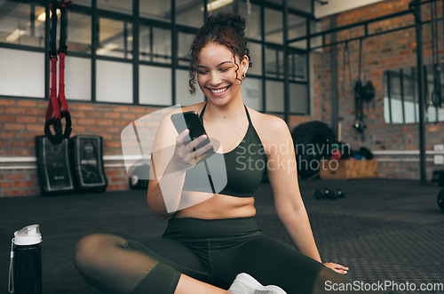 Image of Happy woman, fitness and phone at gym for a workout, training and body wellness with a mobile app. Sports female with smartphone for progress, performance and communication for a healthy lifestyle