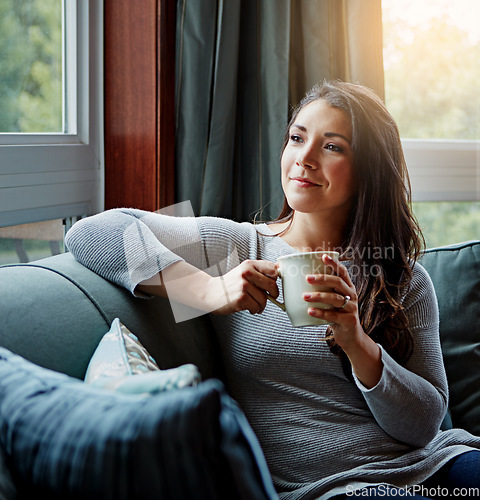 Image of Happiness, coffee and woman thinking, sofa and relax on weekend, break and female in living room. Young lady, girl and tea in lounge on couch, daydreaming and thoughts with ideas, focus and fantasy