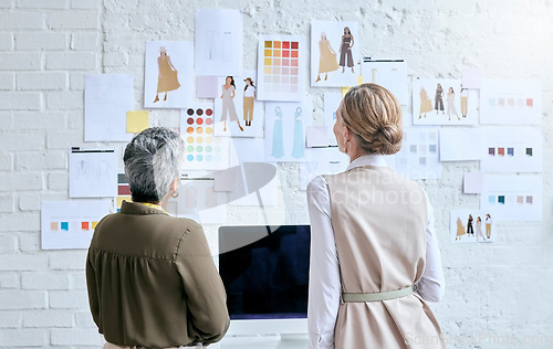 Image of Fashion, designer teamwork and back of women in workshop looking at designs on wall. Collaboration, small business and senior female tailors in boutique planning and discussing color choice or sketch