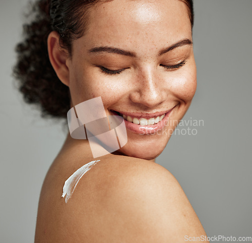 Image of Face, skincare and back of woman with cream in studio isolated on gray background. Cosmetics, beauty dermatology and happy female model with lotion, creme or moisturizer for healthy skin or wellness.