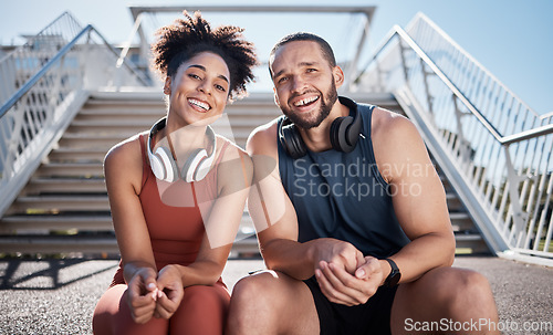 Image of Sports, love and couple on stairs in city on break from exercise workout with smile and headphones. Motivation, health and fitness goals, man and woman rest on New York steps on morning training run.