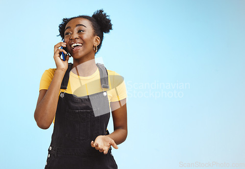 Image of Communication, happy and talking black woman on a phone call isolated on a blue background. Contact, smile and thinking African girl in conversation on a mobile with mockup space on a studio backdrop