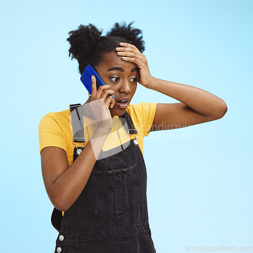 Image of Shocked, surprised and black woman on a phone call for news isolated on a blue background in studio. Wow, crazy and African girl talking about gossip and bad communication on a mobile on a backdrop