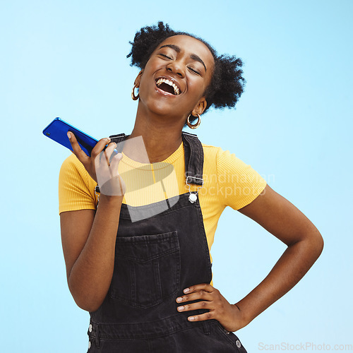 Image of Phone, fashion and black woman laugh on blue background for social media, internet and chat mockup. Communication, advertising and happy girl on call, talking and laughing with smartphone in studio