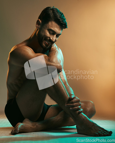 Image of Fitness, wellness and man in neon studio with smile for exercise, bodybuilder training and workout. Beauty, skincare and male model in underwear on floor with muscles, sports goals and motivation