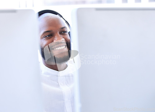 Image of Business, black man and call center for customer support, telemarketing and consulting. African American male employee, consultant and agent with smile, computer and client service for advice or help