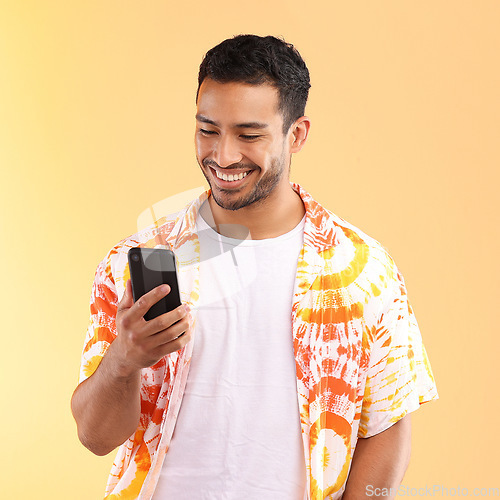 Image of Man with smartphone in hand, smile and happy with chat or social media, communication isolated on studio background. Technology, happiness and funny meme, phone with internet wifi and mockup