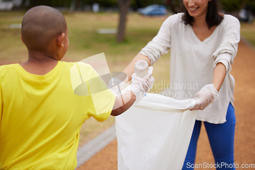 Image of Recycle, sustainability and cleaning trash at a park outdoors by a young volunteer or kid with plastic bottle. Environment, earth day and charity activists to pickup pollution for climate change